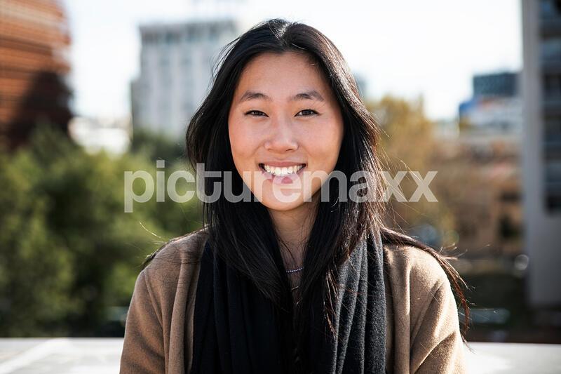 portrait of a happy young woman outdoor - Close up of a smiling asian girl in the city. High quality photo