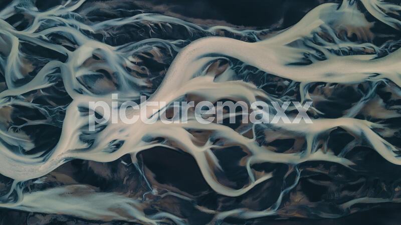 A glacial rivers from above. Aerial photograph of the river streams from Icelandic glaciers. Beautiful art of the Mother nature created in Iceland. Wallpaper background high quality photo.